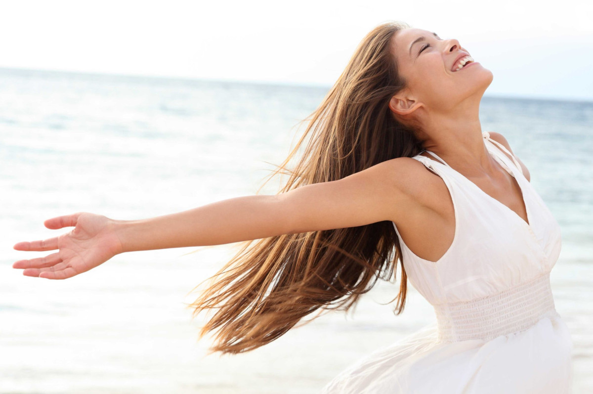 Woman applying lotion before tanning after learning how to prepare for a tanning bed.