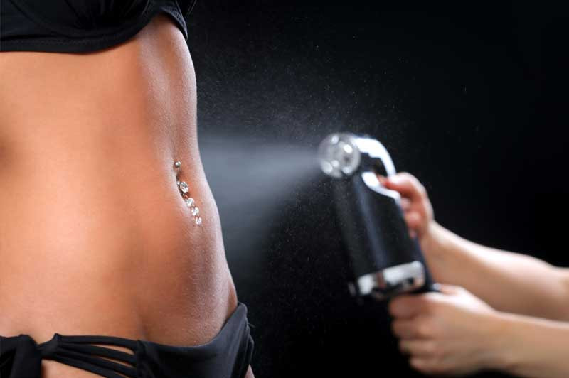 How-to-Prepare-for-a-Tanning-Bed Woman applying lotion before tanning after learning how to prepare for a tanning bed.